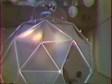 The dome, with CCTV camera mounted in perpex hemisphere on top and balloons in background.