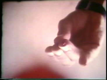 Still from Sequence 24 of Idea Demonstrations. Mike Parr drips blood onto the camera lens.